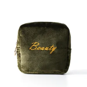 Dark green velvet square sanitary napkin storage bag portable cosmetic pouch with gold embroidery.