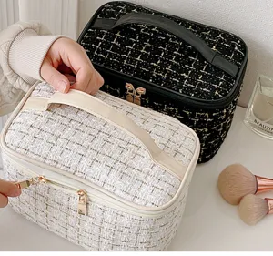 Portable tweed cosmetic bag with large capacity, stylish makeup storage handbag for daily use.