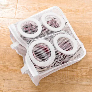 Mesh shoe laundry bag with circular frame for washing and drying shoes safely in machine.