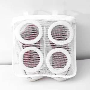 Detail view of white mesh shoe washing bag with circular support rings for machine cleaning.