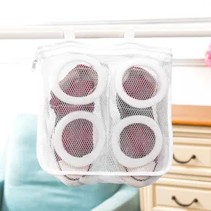 Mesh shoe washing bag for laundry machine, hanging drying pouch with protective rings detail.