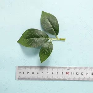 Artificial green leaves branch decoration for home decor and floral arrangement photography props.