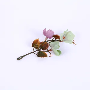 Artificial decorative flower branch with colorful leaves for home vase decor and tabletop setup.