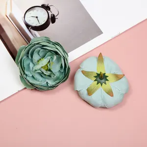 Artificial rose flower heads detail view, green silk floral material for DIY crafts and decor.