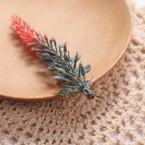 Artificial plant leaf detail shot, green and red succulent foliage decor prop display.