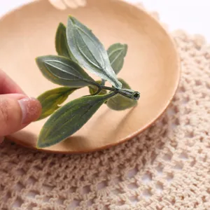 Closeup of artificial green leaf branch detail, perfect for home decor display and arrangement.