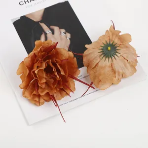Artificial velvet peony flower heads, detail view showing vibrant petals and red stamens.