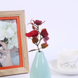 Artificial flower arrangement in ceramic vase for home decor, table centerpiece display.
