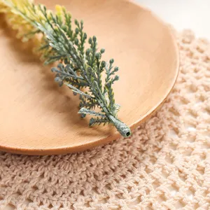 Artificial green plant branch detail shot, perfect for home decoration and floral arrangements.
