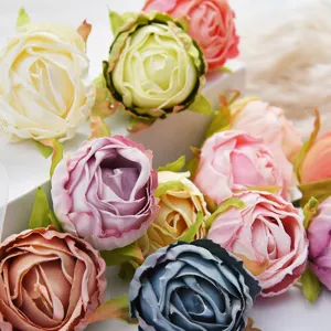 Artificial dahlia flower heads close-up, colorful fabric floral decor for DIY crafts.