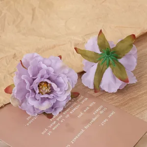 Detail view of artificial purple peony flower head showing multi-layered petals and sepal.