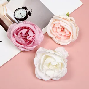 Close-up detail of artificial peony flower heads in pink, white, and beige for DIY crafts.