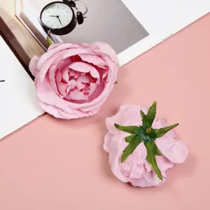 Artificial pink peony flower head for DIY wedding decoration, craft floral detail shot.