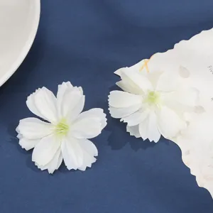 Detail shot of white artificial silk flower heads for DIY crafts and wedding decor.