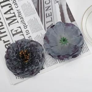 Close-up detail of dark grey artificial silk chrysanthemum flower with multi-layered petals.