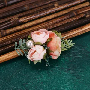 Close-up detail of artificial pink rose hair clip with pearl decor for elegant hanfu styling.