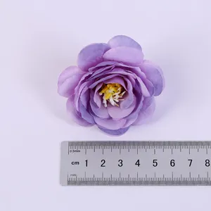 Artificial purple rose flower head detail shot, ideal for home decoration and crafts.