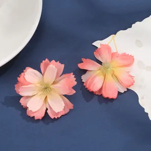 Close-up detail of artificial silk flower heads, gradient pink multi-layered wedding decor.