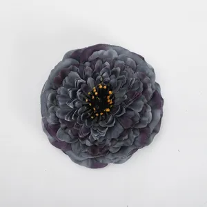 Close-up detail of dark grey artificial chrysanthemum flower head, silk fabric texture, realistic.