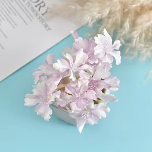 Detail shot of artificial purple and white hydrangea flower head potted decoration, closeup view.