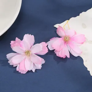 Close-up detail of DIY multi-layer pink silk artificial flower heads for craft decor.