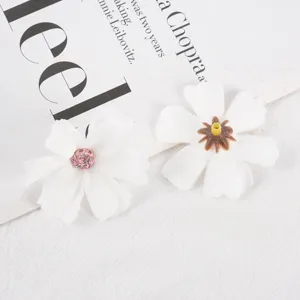 Macro detail shot of white artificial silk flower heads featuring fine stamen textures.