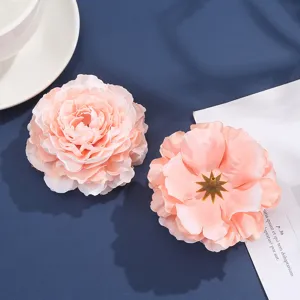 Artificial pink fabric peony flowers for hair accessories, apparel, and hat decoration.