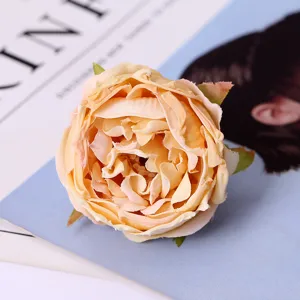 Artificial rose flower head detail close up, fabric silk flower for home wedding decor.