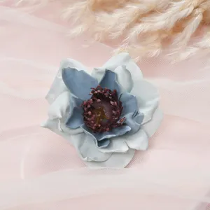 Close up of elegant blue white fabric camellia artificial flower head for home wedding decor.