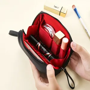 Trousse de maquillage noire portable avec compartiments, idéale pour voyages et rangement quotidien.