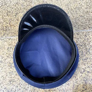 Detailed top view of blue uniform costume police hat with shiny black brim for cosplay events.