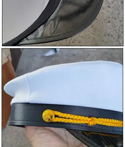 Close-up detail of white captain sailor hat featuring golden star button and black brim.