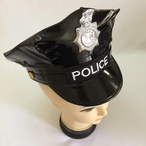 Close-up of black patent leather police hat with silver badge and embroidered police text.