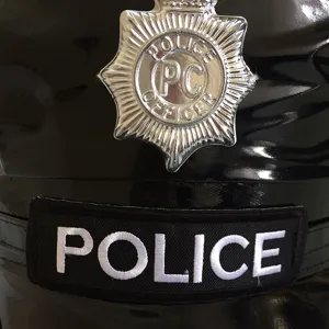 Detail view of the black leather police costume hat featuring silver badge and police patch.