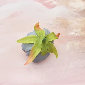 Artificial dahlia flower head detail, grey and green fabric floral decor material for DIY crafts.