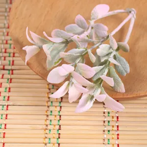 Detailed close-up of artificial decorative pink and green leaves, perfect for flower arrangement.