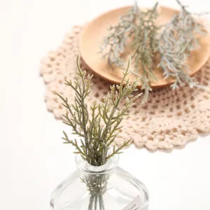 Artificial green plant detail, realistic cypress leaf branch for home and balcony decor.