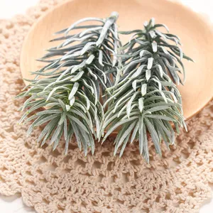 Artificial frosted pine branch detail, lifelike green plant leaves for home interior decor.