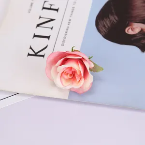 Artificial rose flower head close-up, silk floral decor for wedding and home photography props.