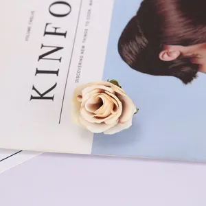 Detail view of artificial silk rose flower head photography prop for home wedding decor.