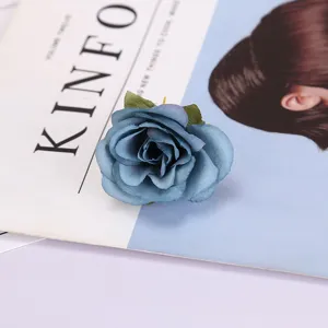 Blue artificial rose flower head for photography props and home decor, realistic silk floral detail.