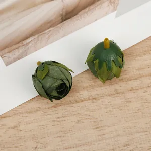 Artificial green rose flower buds DIY craft faux floral heads for home decor and handmade projects.