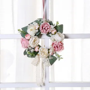 Artificial rose flower wreath detail shot, romantic pink and white floral door hanging decoration for home.