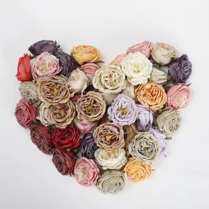 Artificial burnt-edge roses in heart shape for wedding decor and floral arrangement details.