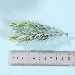 Artificial green plant leaf detail branch close-up showing length with ruler for home decor.