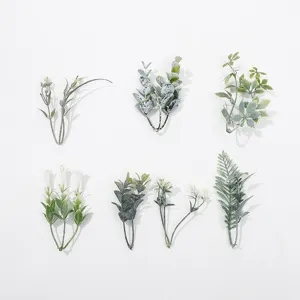 Close-up details of assorted artificial green plant leaves, perfect for DIY crafts and decor.