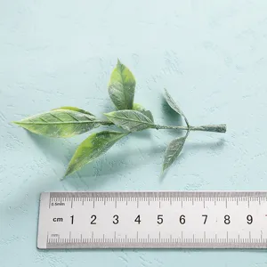 Artificial green plant leaf branch for home decor, realistic simulation foliage detail shot.