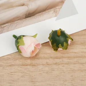 Artificial rose flower heads detail shot, DIY craft fabric floral accessories for home decor.