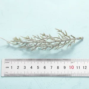 Close-up view of artificial frosted plant branch displayed with measurement ruler for sizing.
