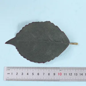 Artificial leaf detail shot showing size with ruler, ideal for home decor floral arrangements.